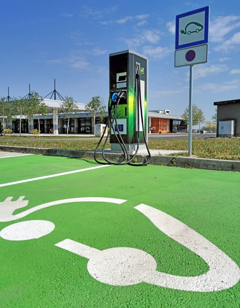 EV charging station on parking lot. Green parking spot for electric vehicles.